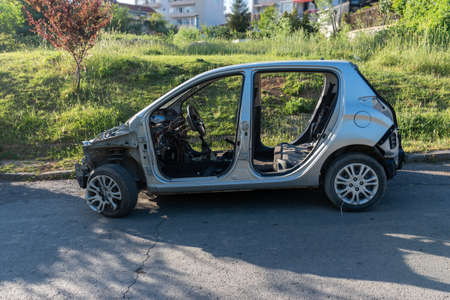 Wreck abandoned car leaving on the street after the traffic accident. From the side viewの写真素材