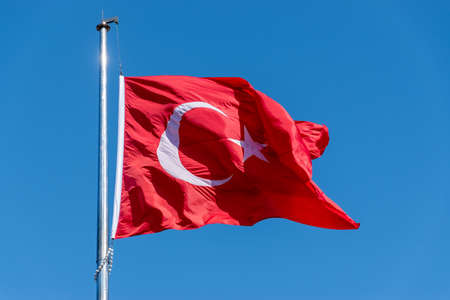 Big Turkish flag waving in the blue skyの写真素材