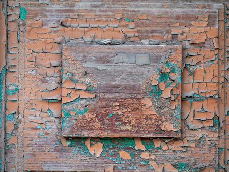 old painted rustic wooden door with cracked paintingsの写真素材