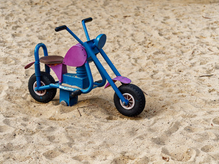 Children's tricycle on the sand on a sunny summer day.の写真素材