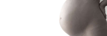 A pregnant woman close up in warm tonesの写真素材