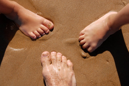 Three barefoot on the sandの写真素材