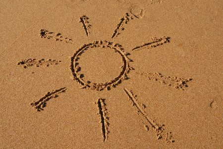 Hand drawn sun in the golden sandの写真素材