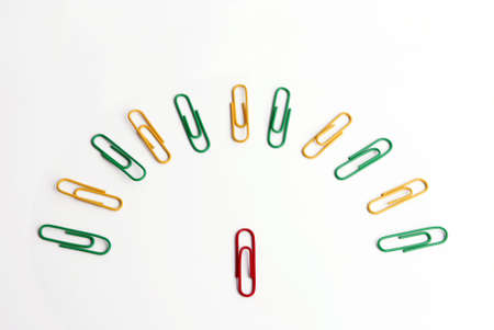 Conceptual idea of leadership. Half a circle formed with colored paper clips and another in front of them.の写真素材