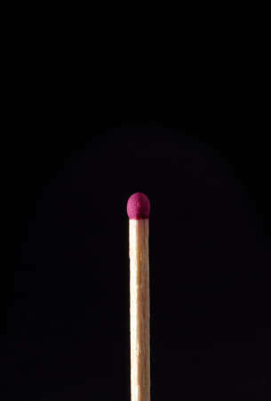 A regular non struck match isolated on black.の写真素材