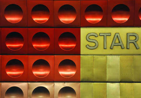 Red and golden circled metal texture with the word star.の写真素材