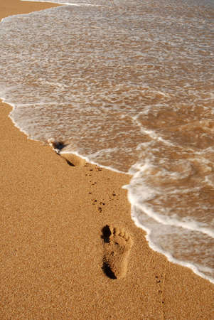 footprints on the sand at the seashoreの写真素材