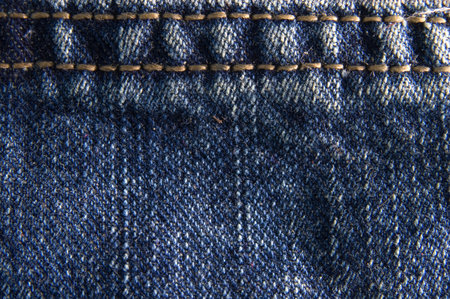 Blue denim jeans texture macro close up. Useful as background for design works.