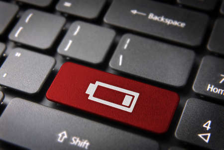 Technology key with low battery icon on laptop keyboard. Included clipping path, so you can easily edit it.の写真素材