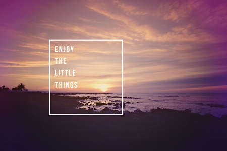 Enjoy the little things motivational inspiring quote concept with soft light sunset landscape background ideal for print card and poster design.の写真素材