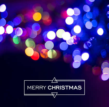 Merry christmas design: simple abstract label on real bokeh light background. Ideal for holiday greeting card, xmas poster or web.の写真素材