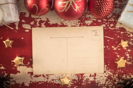 Merry Christmas top view vintage postcard on retro grunge wood background with xmas ornament decoration. Includes clipping path for card.の写真素材