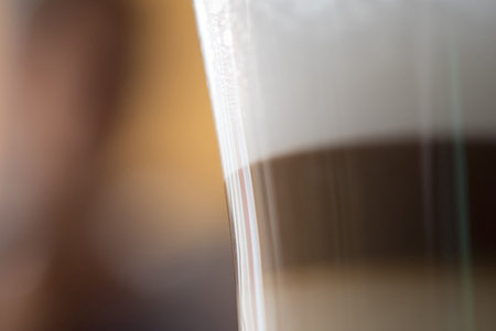 Abstract close up shot of cappuccino foam coffee drink glass, blur background.の写真素材