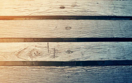 Wooden deck bridge background texture closeup with water below and vintage style filter.の写真素材