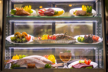Elegant seafood display at restaurant with fish, shrimp, lobster and vegetable decoration.の写真素材