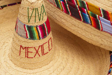 Mexican sombrero hats with colorful decoration and viva mexico quote in street market display of souvenirs.の写真素材