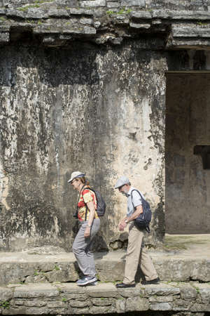CHIAPAS, PALENQUE, MEXICO â MARCH 1, 2016: senior tourist couple walk the ruins of Palenque archaeological site. This popular tourist attraction is sorrounded by rainforest, Mexico, Central America.のeditorial素材