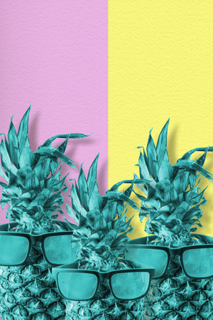 Trendy tropical pineapple fruit with sunglasses in colorful retro style, happy summer concept.の写真素材