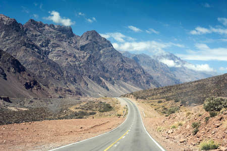 Mountain nature landscape with empty road. Summer backpacking adventure in Argentina, beautiful desert hill scenery of south america.の写真素材