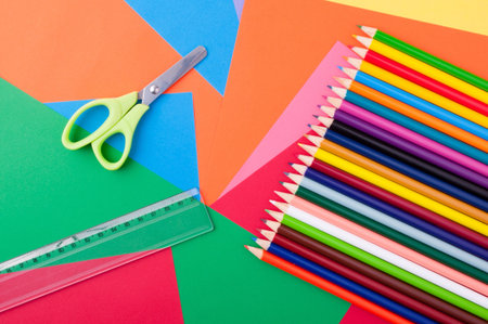 school supplies with leaves and colored pencils