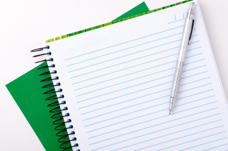 Blank spiral notebook with pen for notes