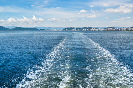 Boat trail in the sea with views of the island city of Santos in Sao Paulo