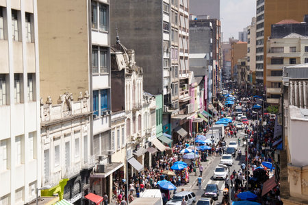 Sao Paulo, Brazil - January 20, 2014: People walk in the street March 25, in Sao Paulo, Brazil. The...