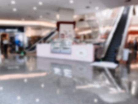 People walking in shopping mall. Intentional blurred added post production. Creative abstract...