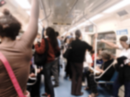 People inside the train wagon at subway station. Intentional blurred added post production. Creative abstract background with blurred in modern style.の写真素材