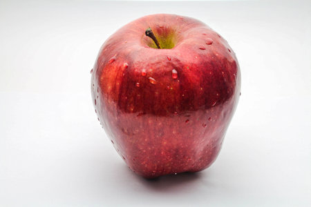 Red apple with drops of waterの写真素材
