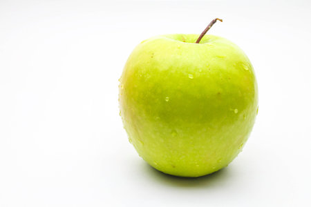 Green apple with drop of waterの写真素材