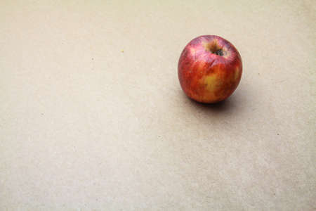 Apple isolated on seamless brown paper backgroundの写真素材