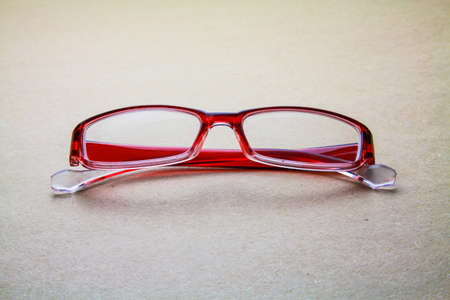 Eyeglasses isolated on seamless brown paper backgroundの写真素材