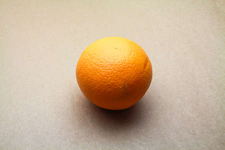 Orange Fruit isolated on seamless brown paper backgroundの写真素材