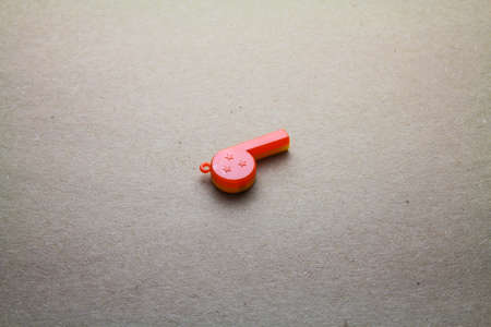 Whistle isolated on seamless brown paperの写真素材