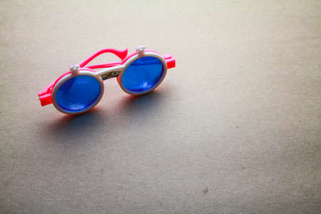 Children sunglasses isolated on seamless brown paper の写真素材