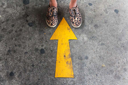 Up sign with a gilr stonding overの写真素材