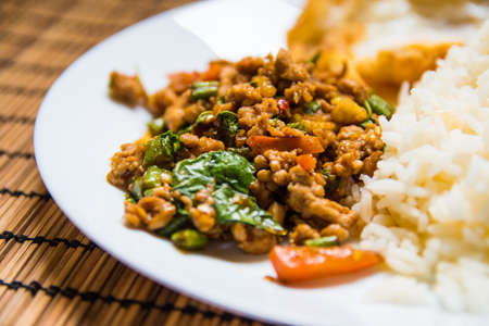 Rice topped with stir-fried pork and basilの写真素材