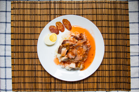 Barbecued red pork and crispy pork in sauce with riceの写真素材