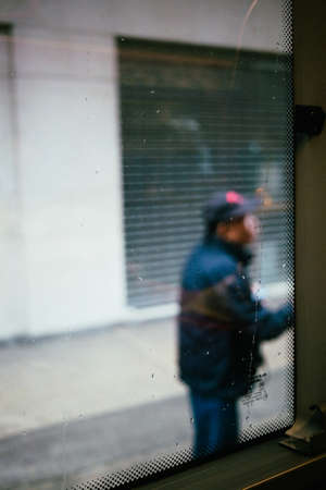 On a bus, Rain drop on a window, outside is a people and city, Japanの写真素材