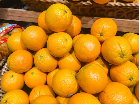 Pile of oreanges on a wooden basket