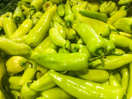 Pile of green bell pepper shot in supermarketの写真素材
