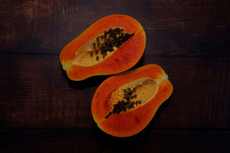 slices of papaya on the wooden background