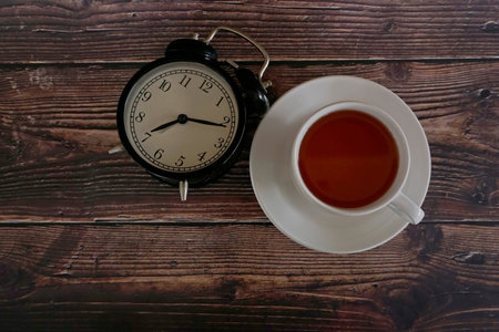 a cup of tea with alarm clock