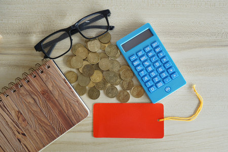 coins with note book and calculator on the table. Business concept