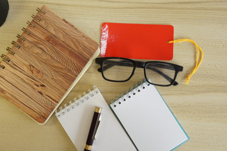 eyeglass and note book on the tableの写真素材
