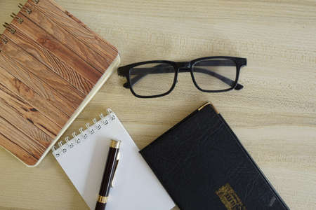 eyeglass and note book on the tableの写真素材