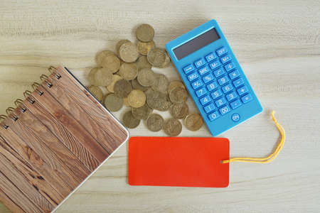 coins with note book and calculator on the table. Business conceptの写真素材
