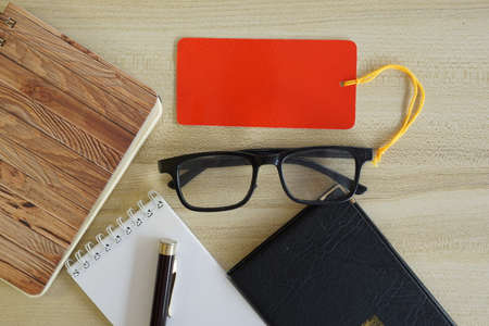 eyeglass and note book on the tableの写真素材