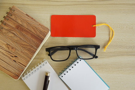 eyeglass and note book on the tableの写真素材